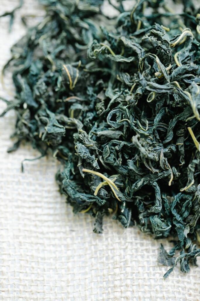 pexels-photo-8330328-8330328 Detailed view of dried herbal tea leaves on burlap, perfect for health and wellness themes.